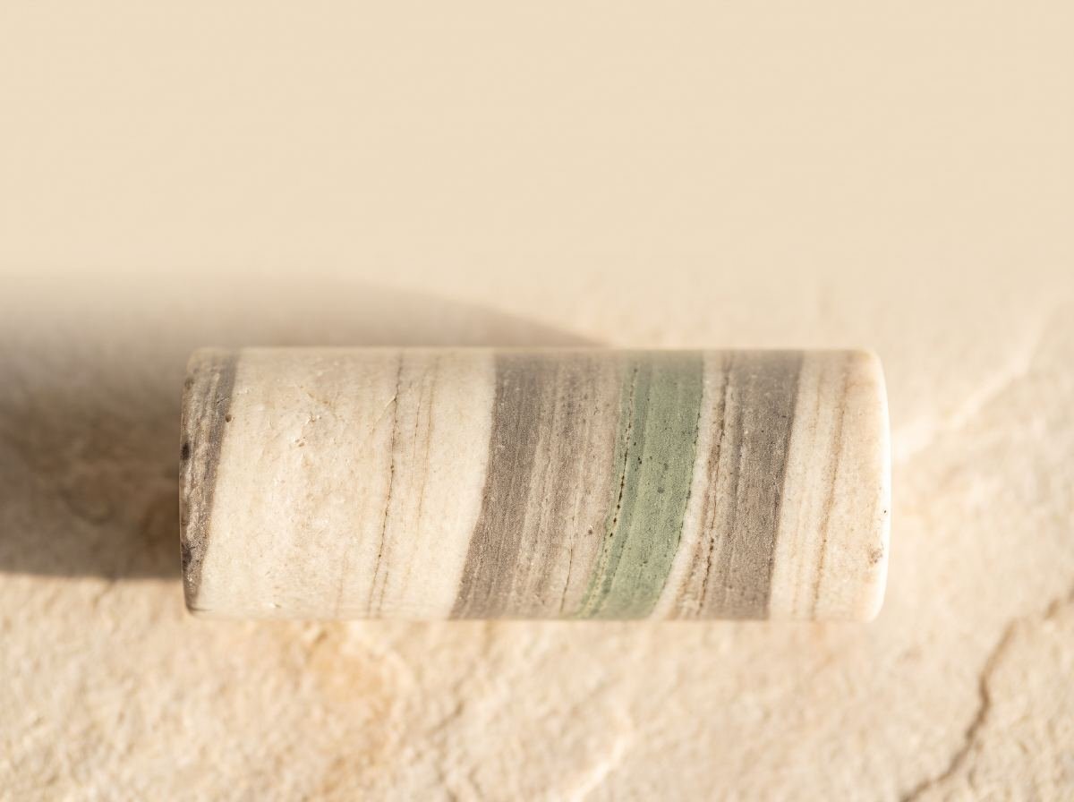 Overhead macro photograph of a layered mineral core sample
